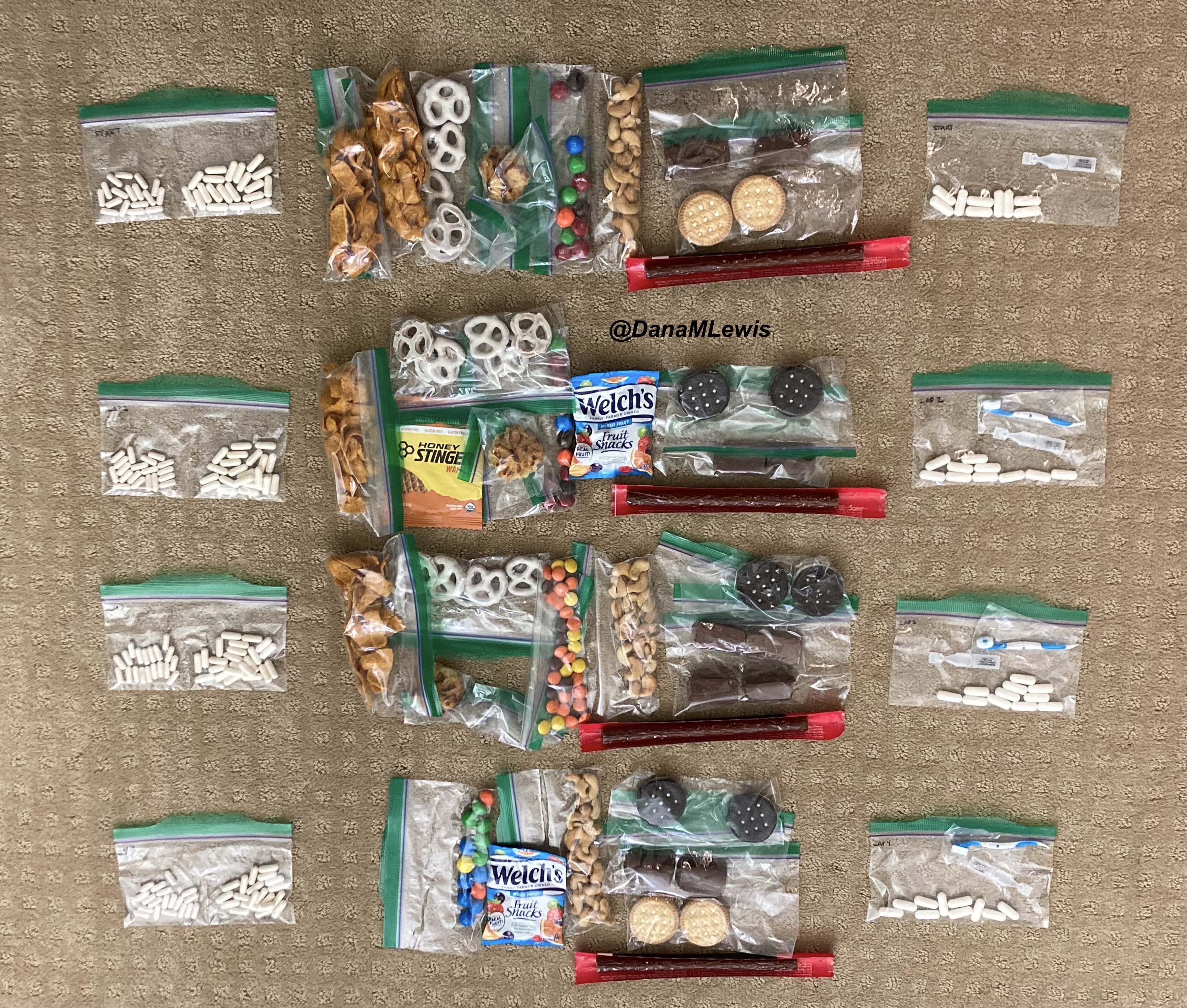 My 100k run supplies set out on the floor. I have a bag of OTC enzymes (for exocrine pancreatic insufficiency), 8-10 individually packaged snacks ranging from Fritos to yogurt pretzels to sandwich cookies, cashews, and beef sticks, a bag of electrolyte pills, and eye drops and disposable tooth brushes. Each lap (4 total) has a set of each of these.